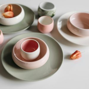 close up of a round pink and green pastel colored cup and bowl set