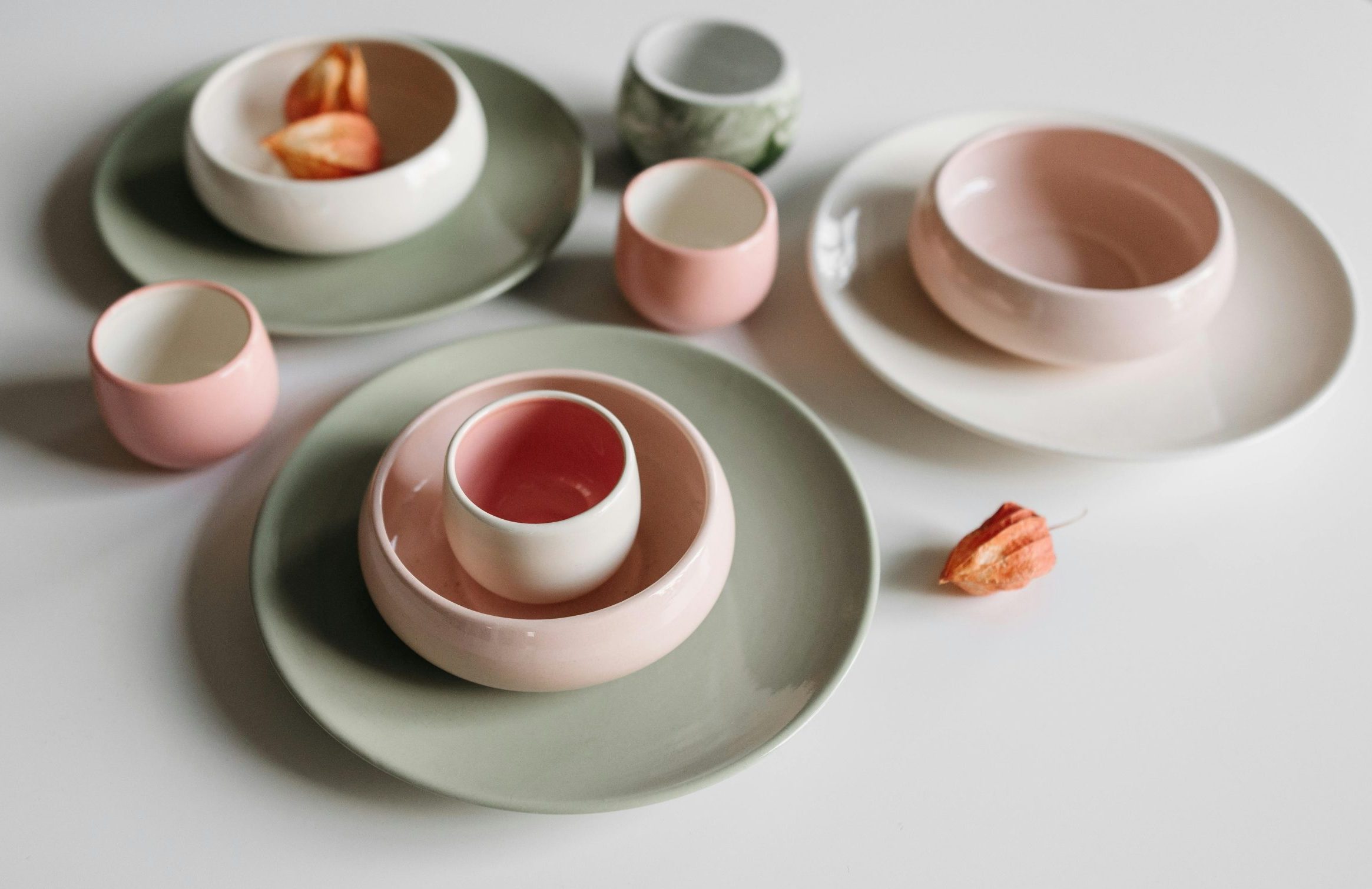 close up of a round pink and green pastel colored cup and bowl set
